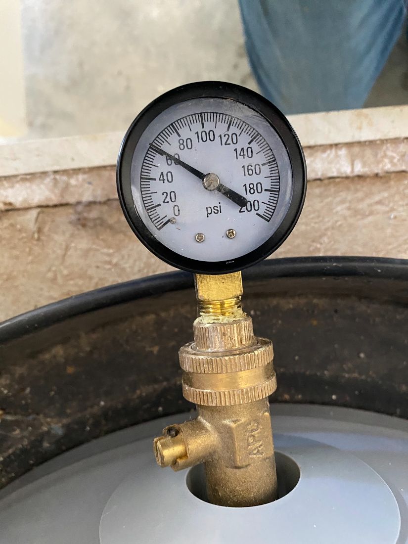 Pressure gauge testing a water heater expansion tank