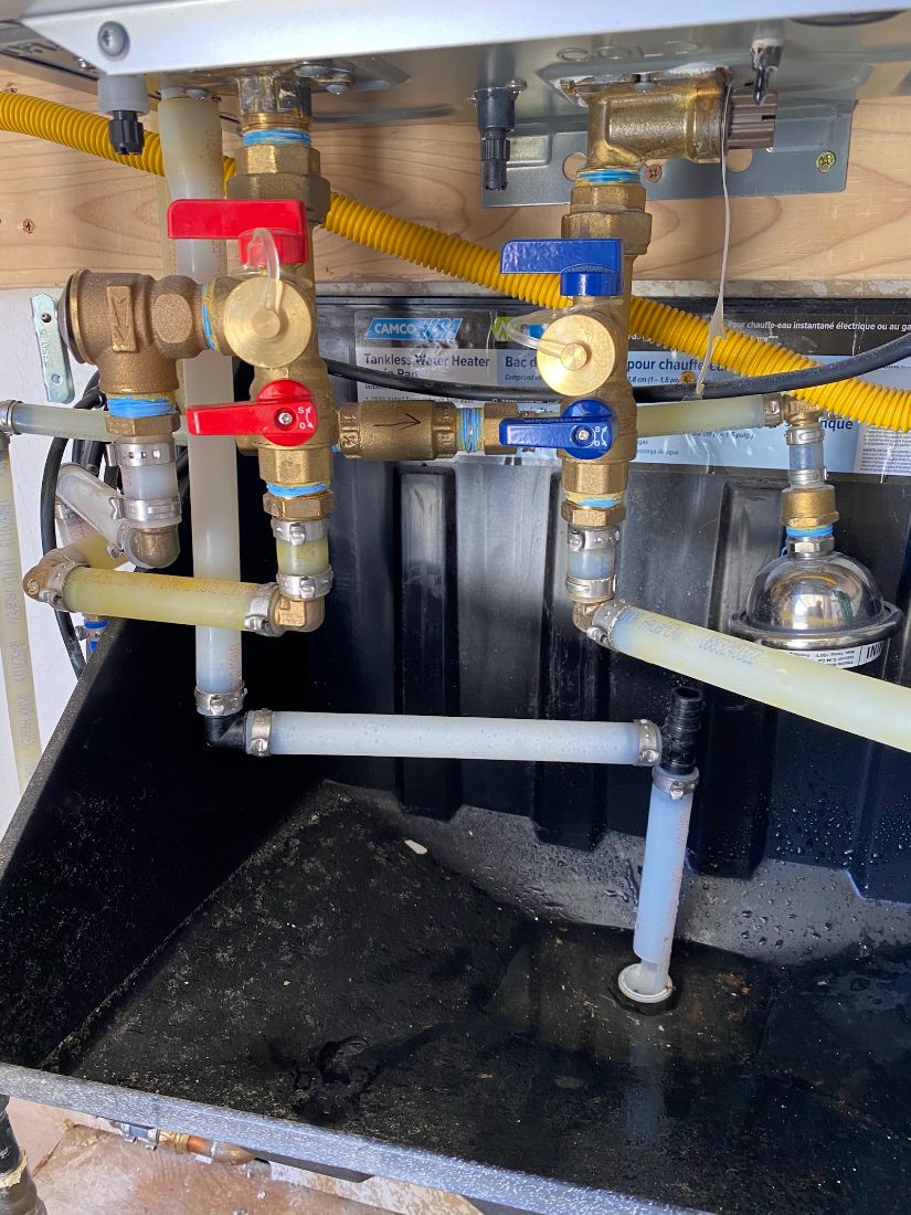 Tankless water heater gas and water shutoff valves with drip pan