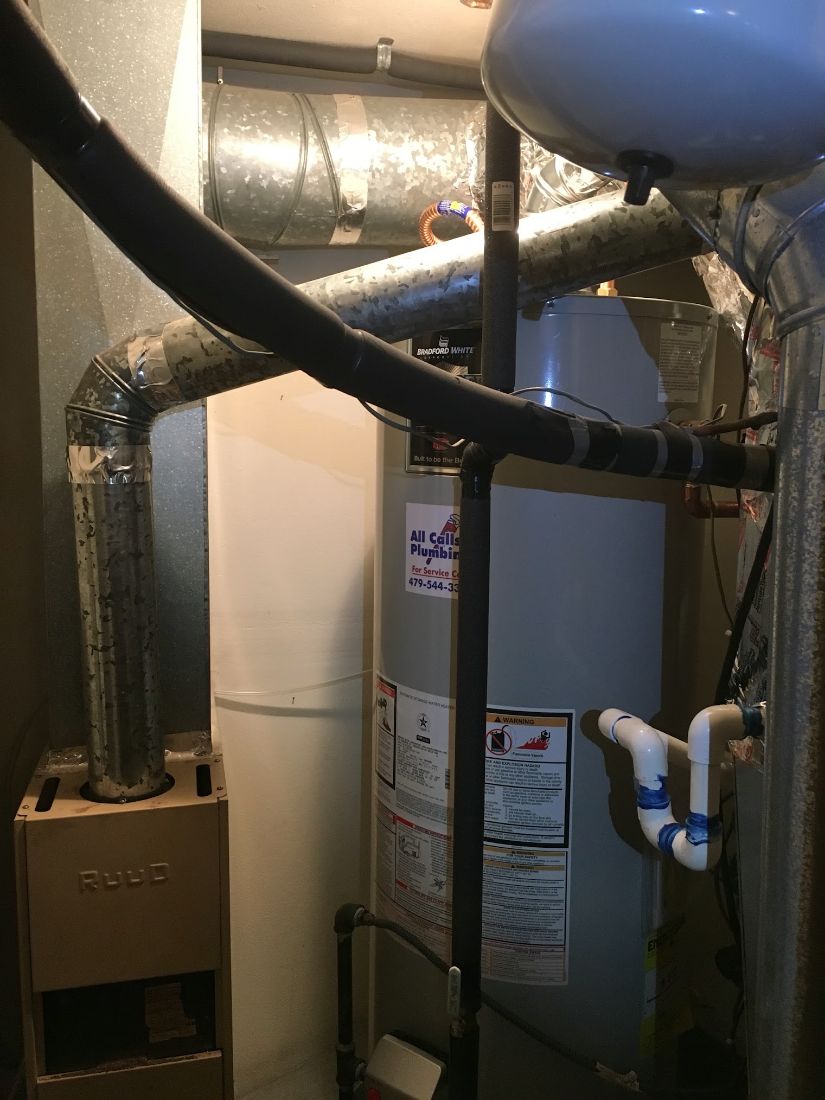 Bradford White water heater installed with an All Calls Plumbing service sticker